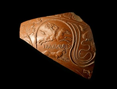 Fragment of a bowl decorated with a man hunting a stag, stamped by the manufacturer Cinnamus, from the Roman site at Newstead, AD 140-80 by Samian Samian